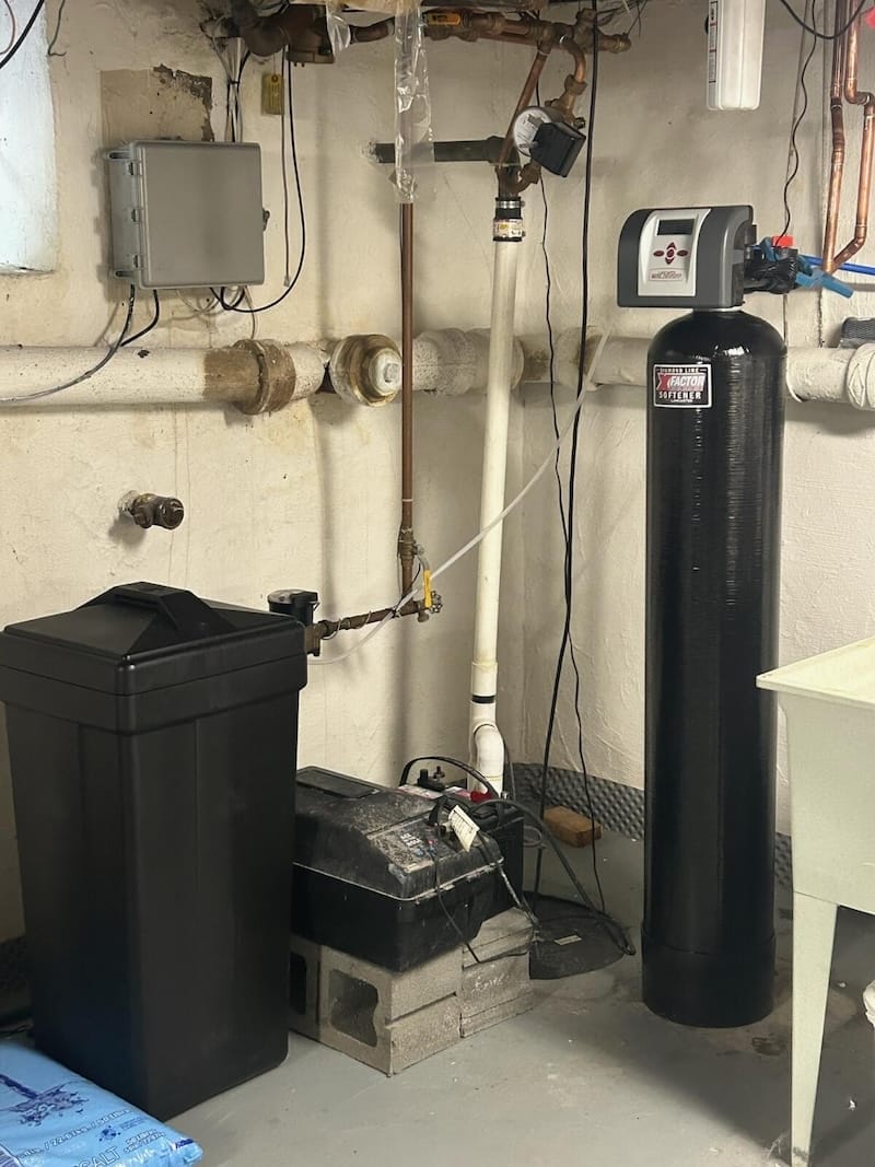 Water softener system with brine tank installed in basement