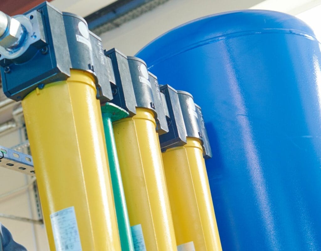 Whole-house water filtration system with tanks and filters