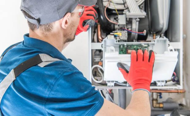 HVAC technician servicing high-efficiency furnace system