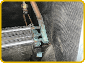Dirty HVAC coils showing severe dust buildup and need for professional cleaning.
