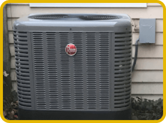 Outdoor Rheem central air conditioning condenser unit positioned outside a home, showing HVAC installation standards.