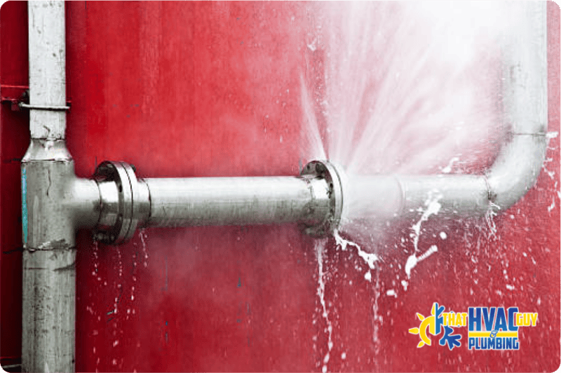 Burst pipe spraying water during an emergency plumbing leak.